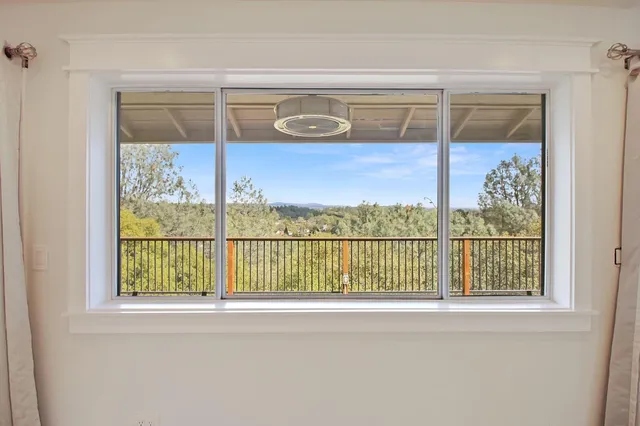 a view of kitchen with stainless steel appliances granite countertop a sink a stove a refrigerator and white cabinets