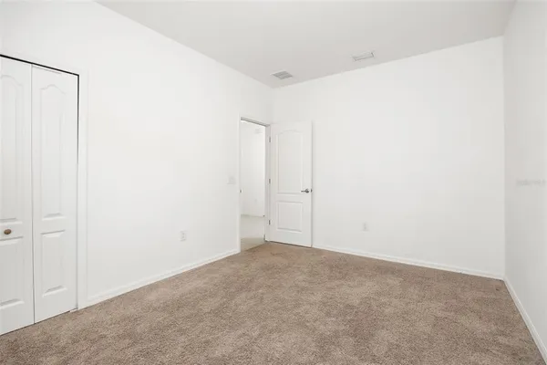 a bathroom with a granite countertop shower sink and mirror