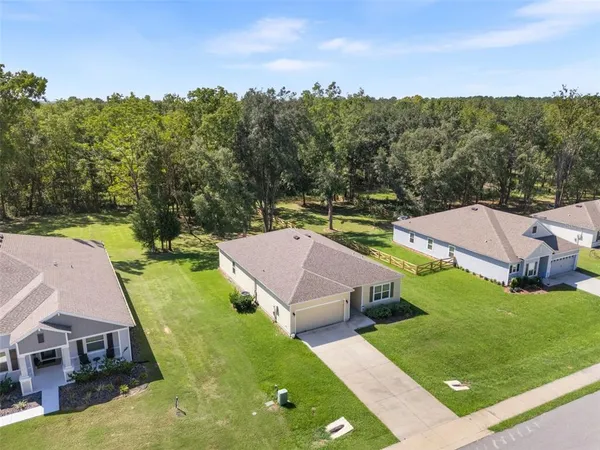 an aerial view of multiple houses with yard