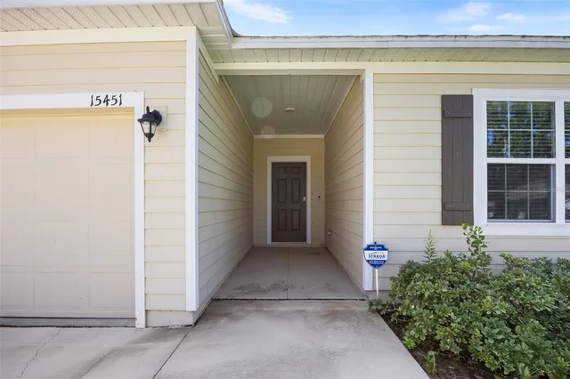 a bedroom with a bed a tv and wooden floor