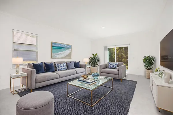 a living room with furniture and a large window