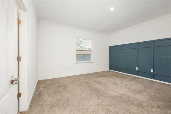 an empty room with windows and closet