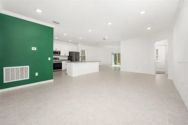 a view of kitchen with kitchen island and stainless steel appliances