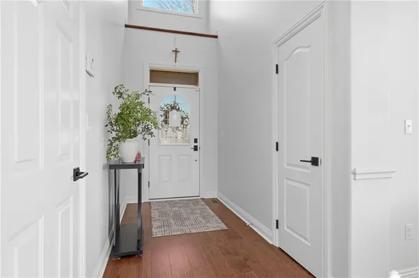 a view of a hallway with wooden floor and closet