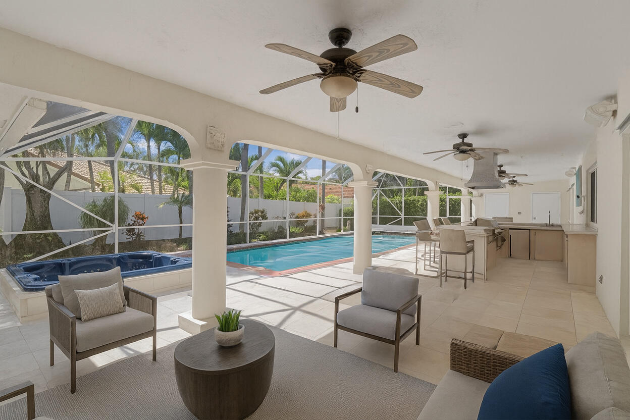 620 Southwest 17th Street Boca Raton, FL 33486 - Photo 12 of 40 a living room with furniture a fireplace and a floor to ceiling window