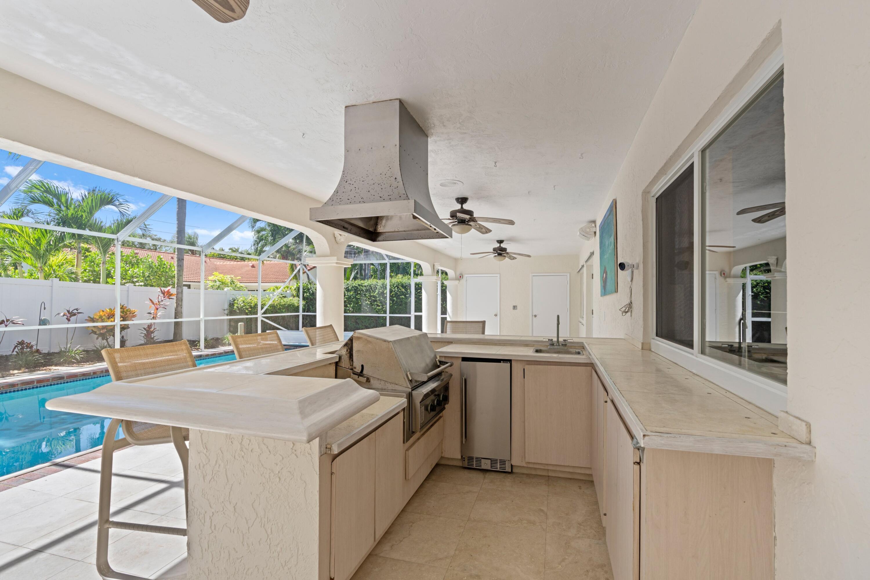 620 Southwest 17th Street Boca Raton, FL 33486 - Photo 14 of 40 a kitchen with stainless steel appliances granite countertop a sink and a stove