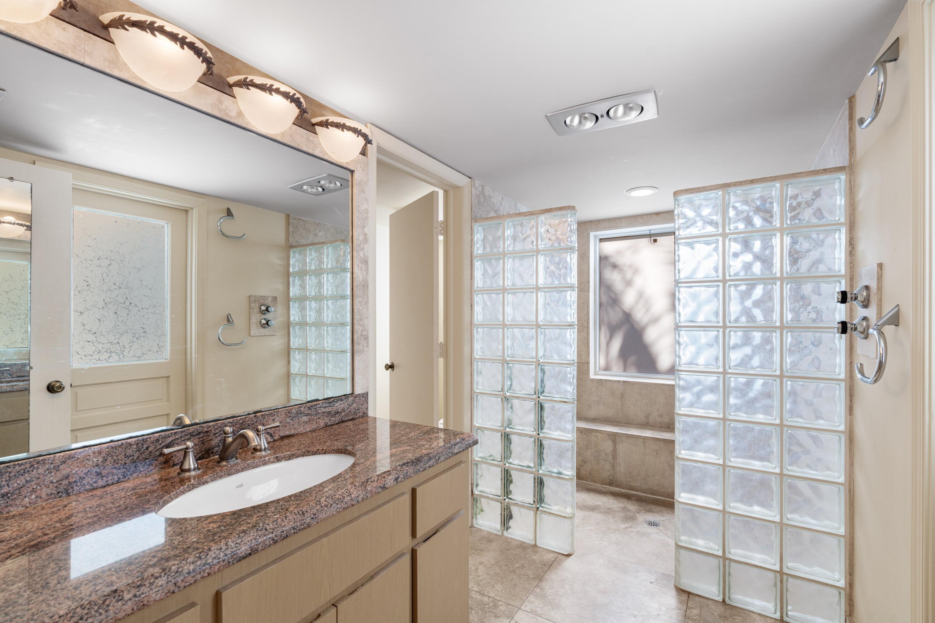 620 Southwest 17th Street Boca Raton, FL 33486 - Photo 19 of 40 a bathroom with a granite countertop sink a mirror and a shower