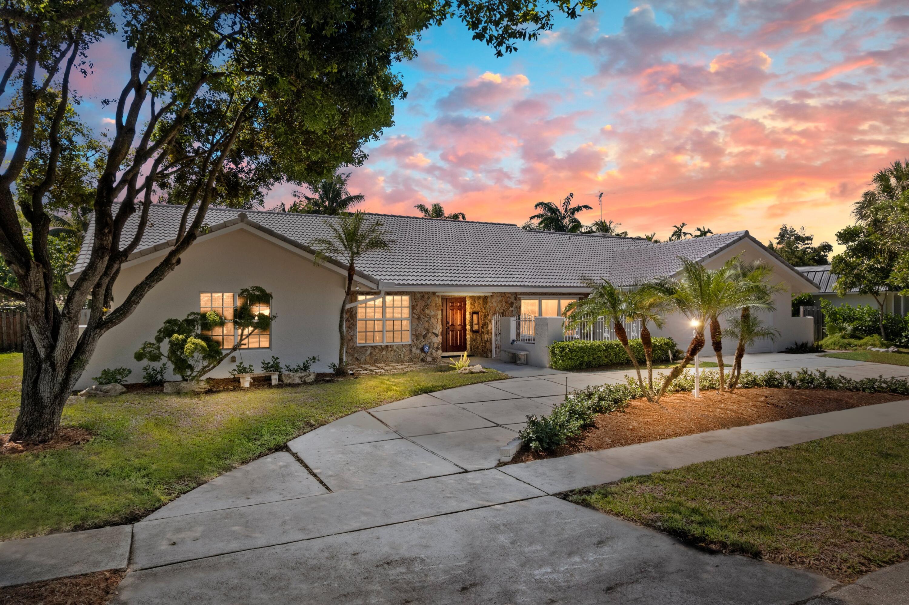 620 Southwest 17th Street Boca Raton, FL 33486 - Photo 2 of 40 a view of a house with a yard and pathway