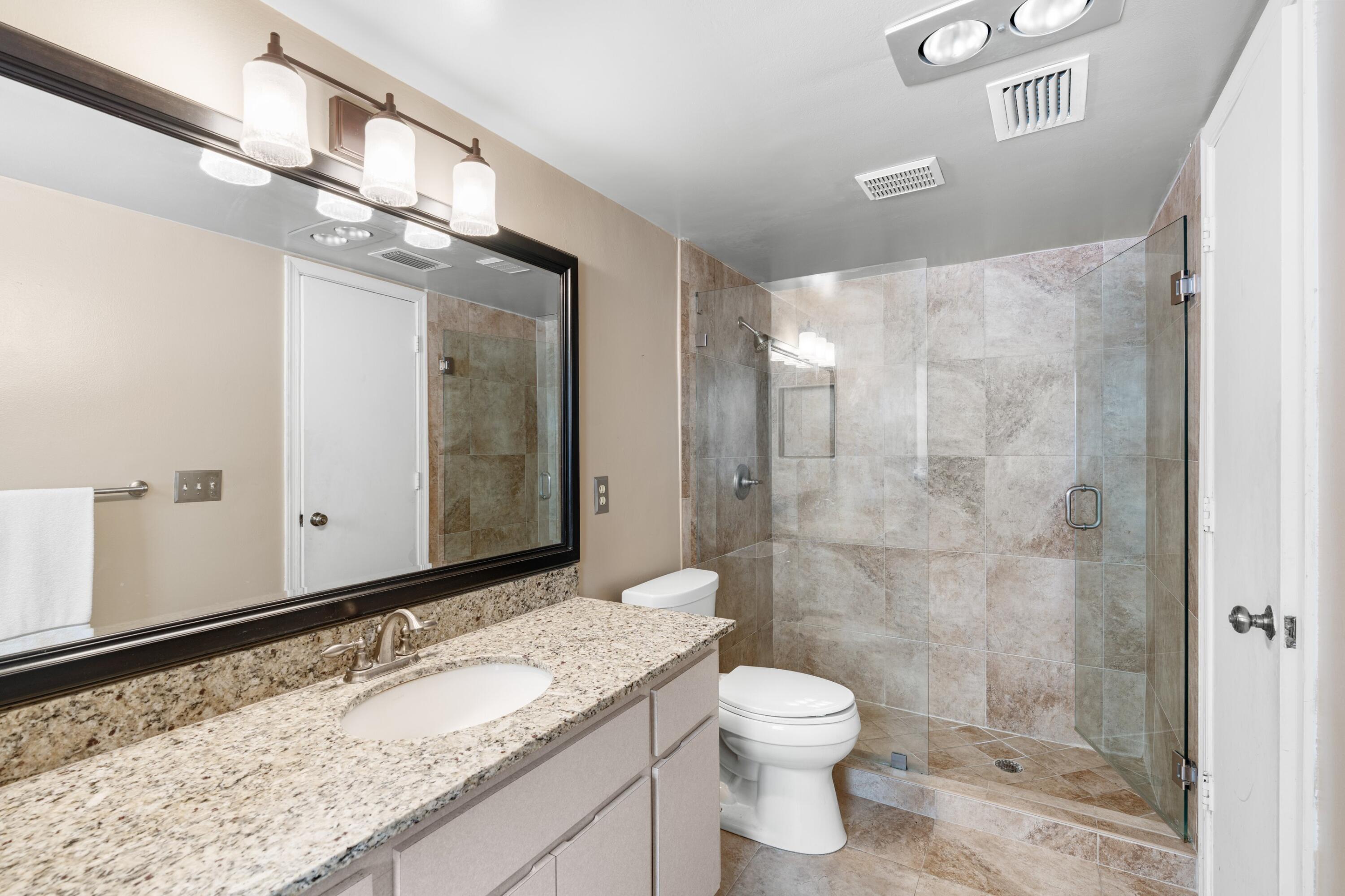 620 Southwest 17th Street Boca Raton, FL 33486 - Photo 21 of 40 a bathroom with a granite countertop sink toilet and shower