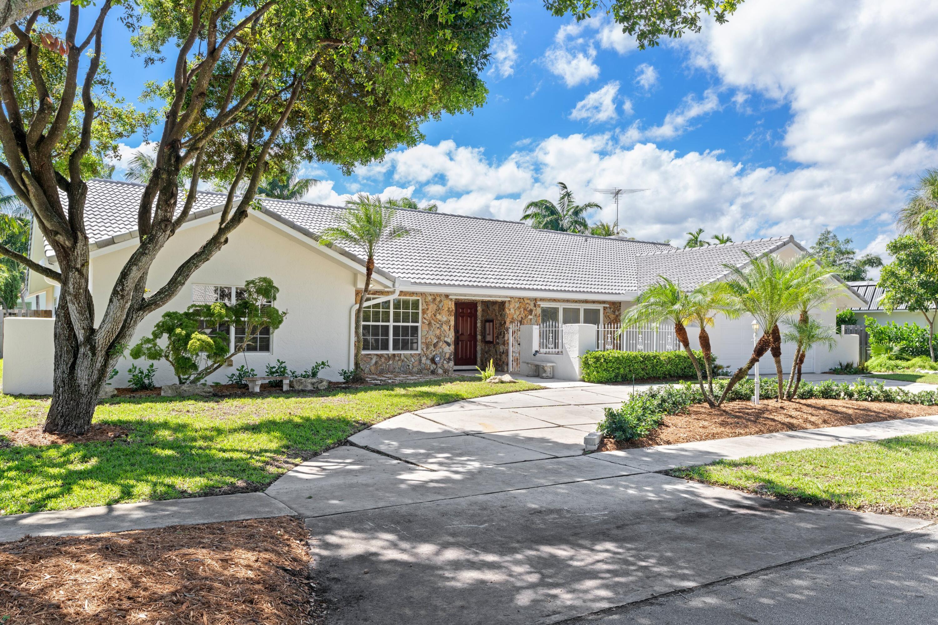 620 Southwest 17th Street Boca Raton, FL 33486 - Photo 23 of 40 a view of a house with a yard and tree s