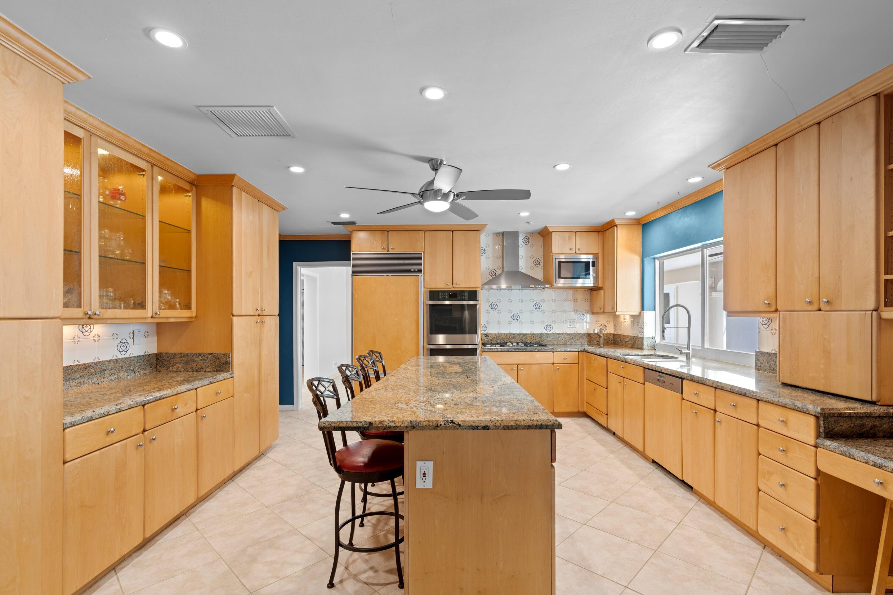 620 Southwest 17th Street Boca Raton, FL 33486 - Photo 6 of 40 a large kitchen with kitchen island granite countertop lots of counter top space and stainless steel appliances