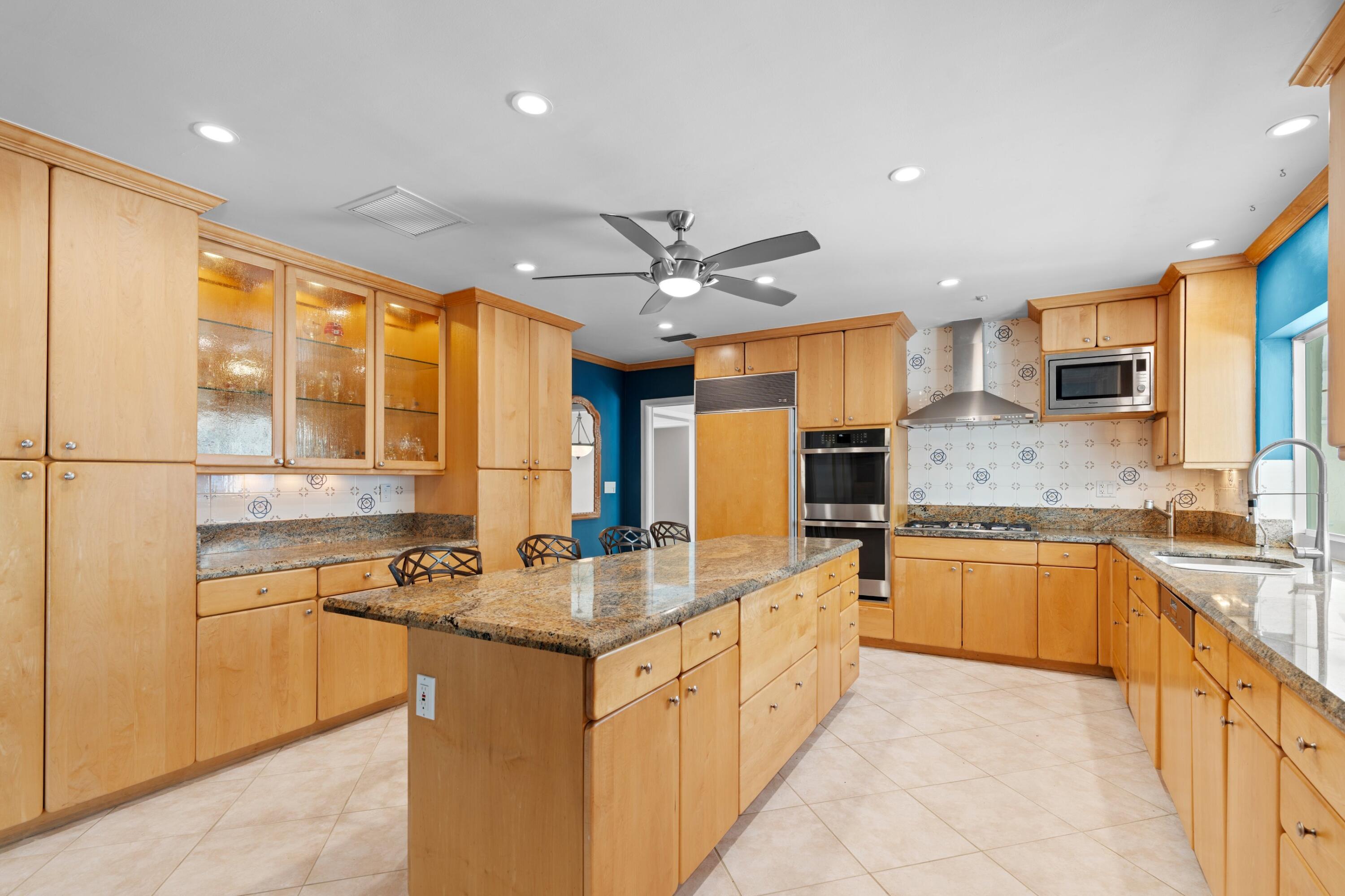 620 Southwest 17th Street Boca Raton, FL 33486 - Photo 7 of 40 a kitchen with stainless steel appliances granite countertop a sink stove and refrigerator