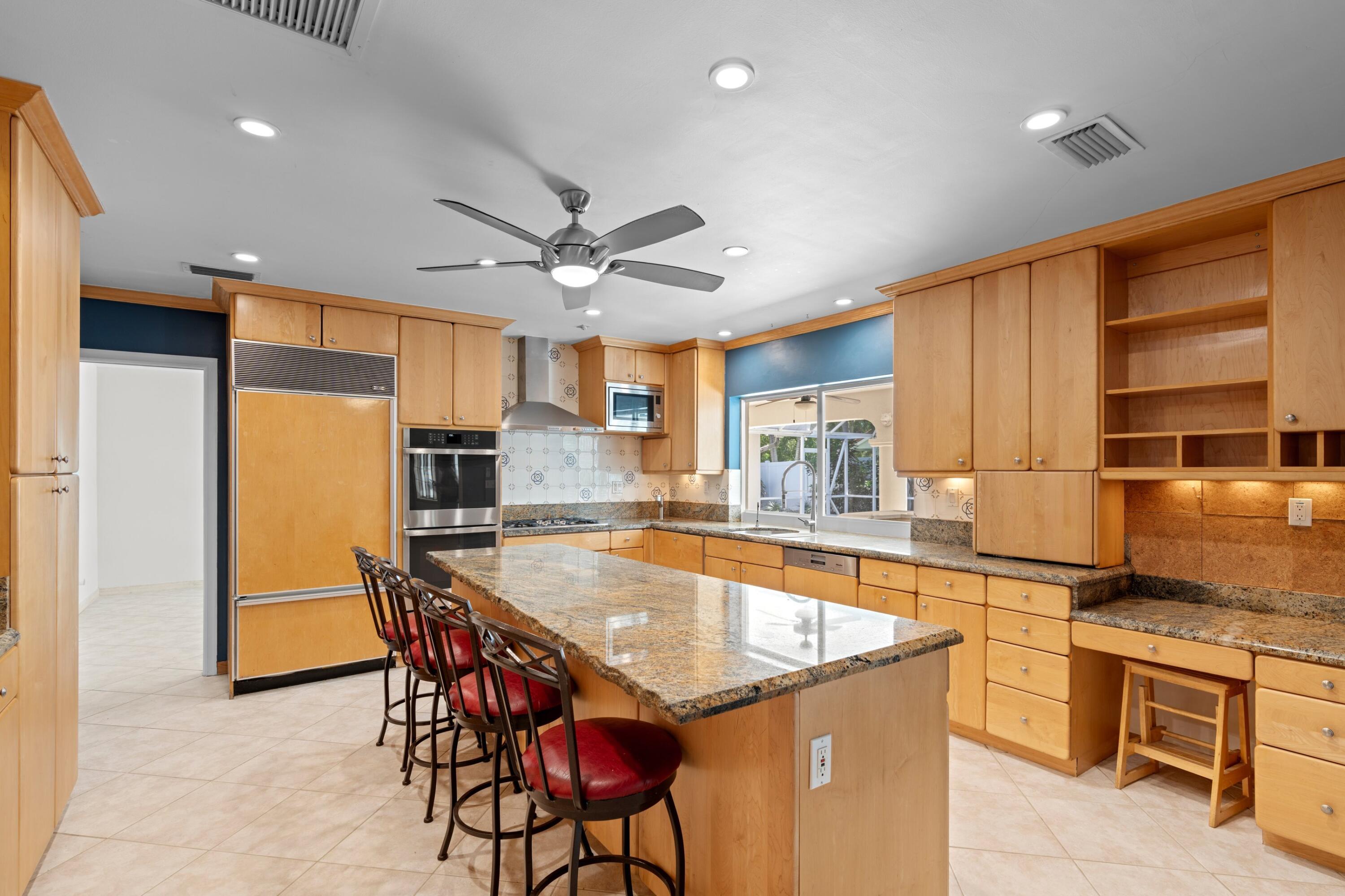 620 Southwest 17th Street Boca Raton, FL 33486 - Photo 8 of 40 a large kitchen with a table and chairs in it