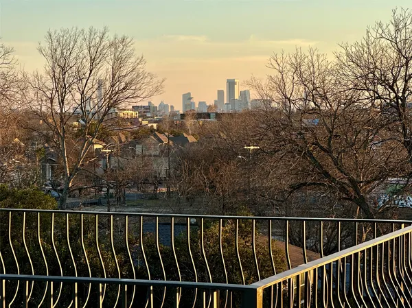 a balcony with wooden floor and city view