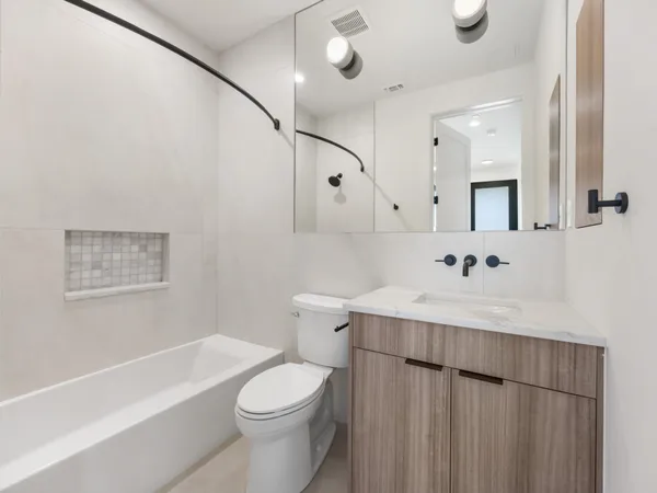 a bathroom with a sink toilet and shower