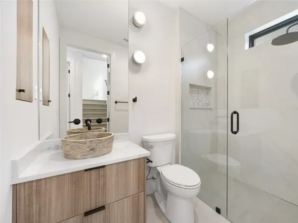 a bathroom with a sink toilet and shower