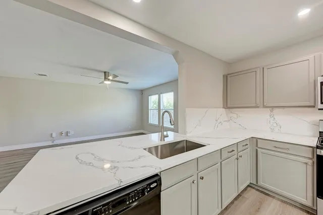 a kitchen with a sink cabinets and window