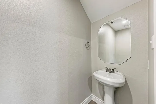 a bathroom with a sink and mirror