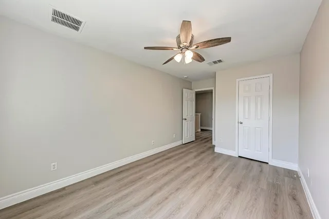 a view of an empty room and wooden floor