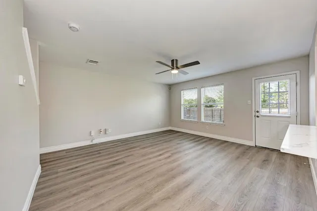 wooden floor in an empty room with a window
