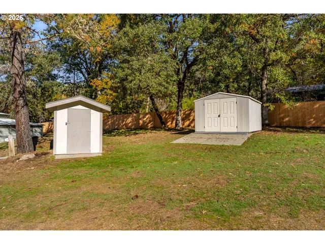 a view of a house with a yard and garage