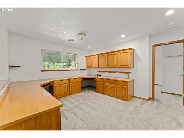 a view of an empty room and a window