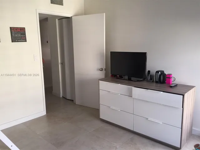 a room with furniture and flat screen tv