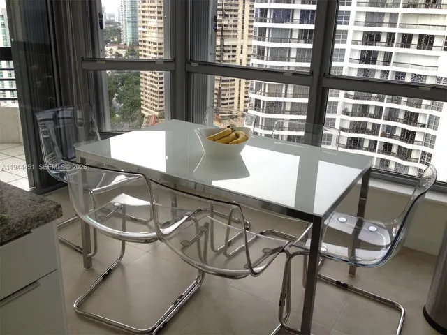 a dining room with table and chairs