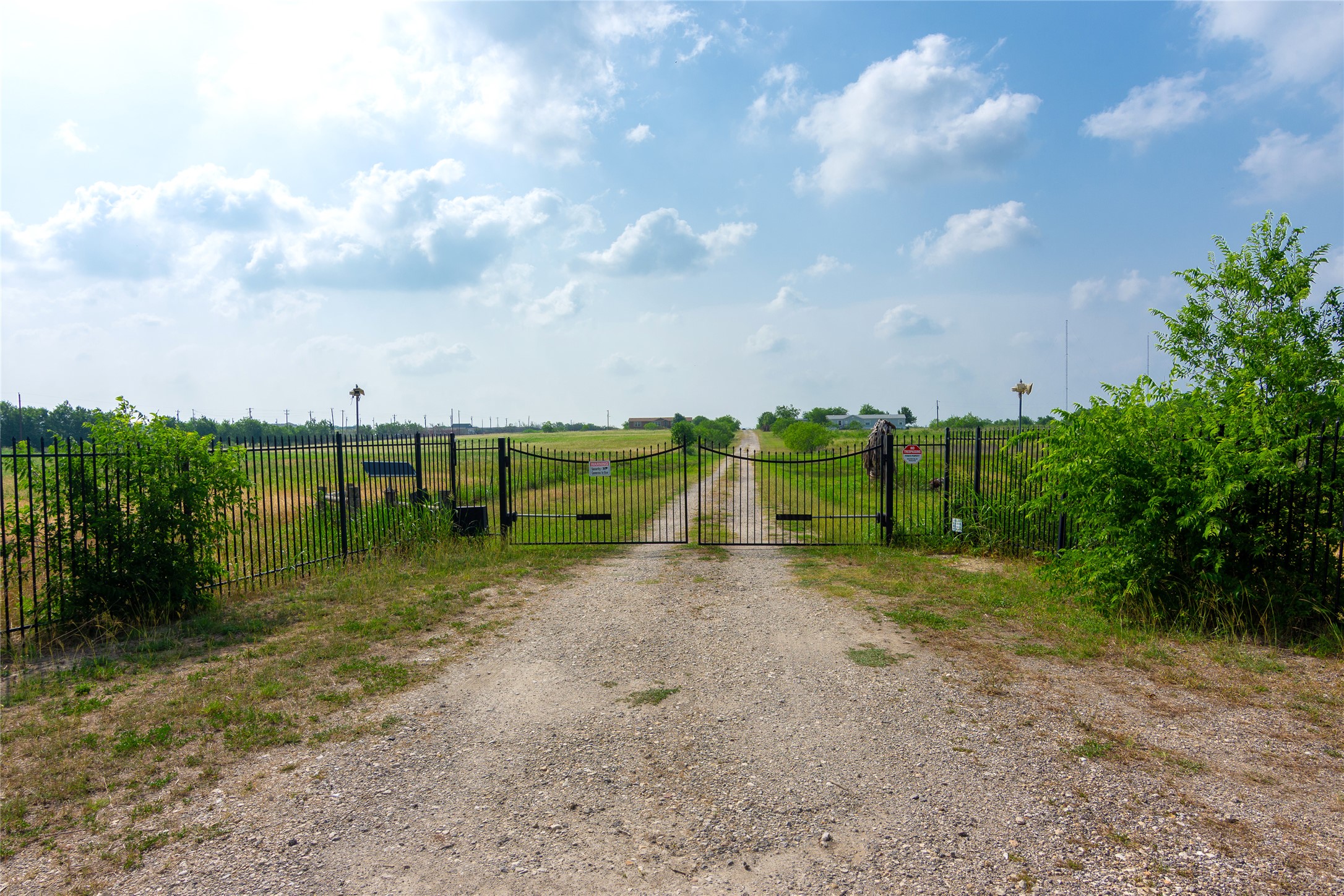 1 11209-tract Road Del Valle, TX 78617 - Photo 1 of 39 View of road featuring a gate, a rural view, and a gated entry