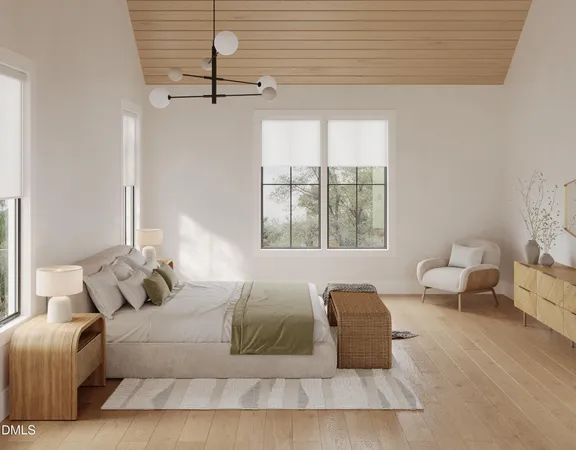 a spacious bedroom with a bed a couch and windows