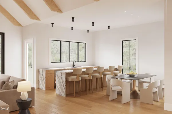 a room with lots of white furniture and windows