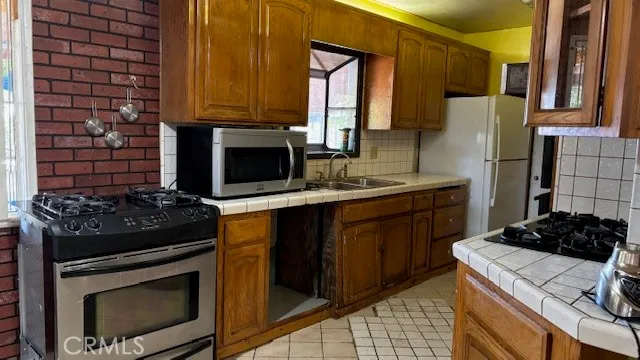 a kitchen with a stove and a refrigerator