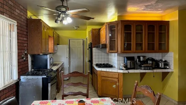 a kitchen with a sink appliances and cabinets