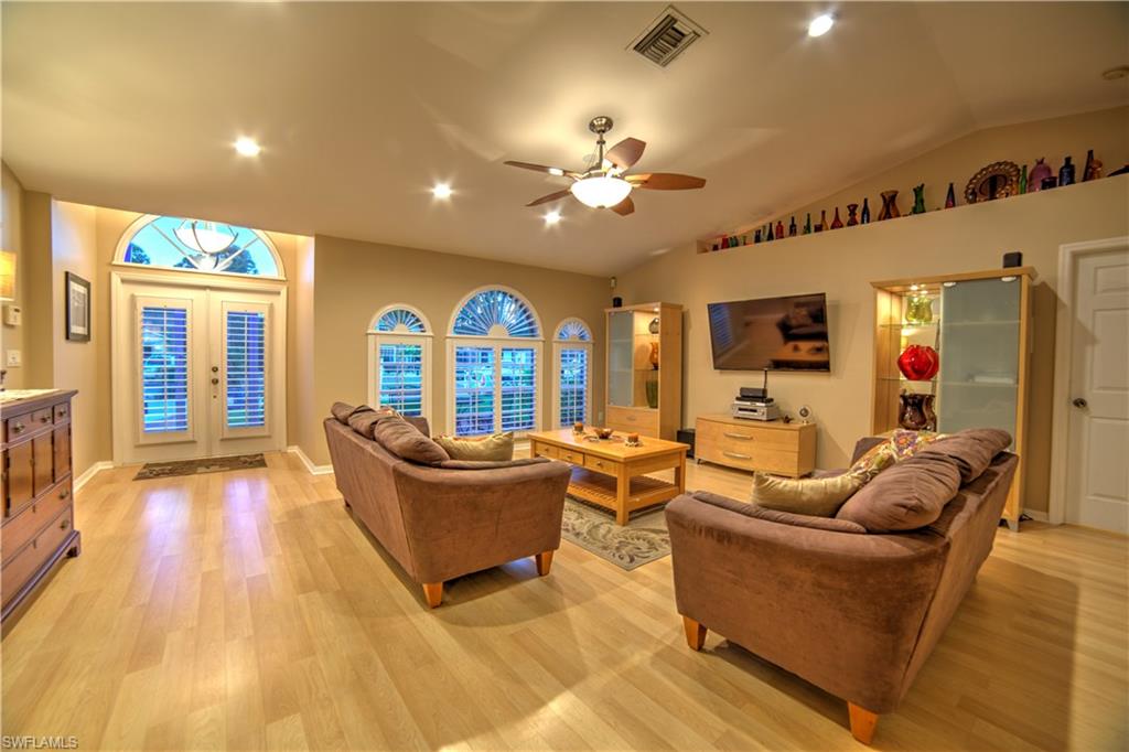 9143 Irving Road Fort Myers, FL 33967 - Photo 2 of 14 a living room with furniture and a flat screen tv