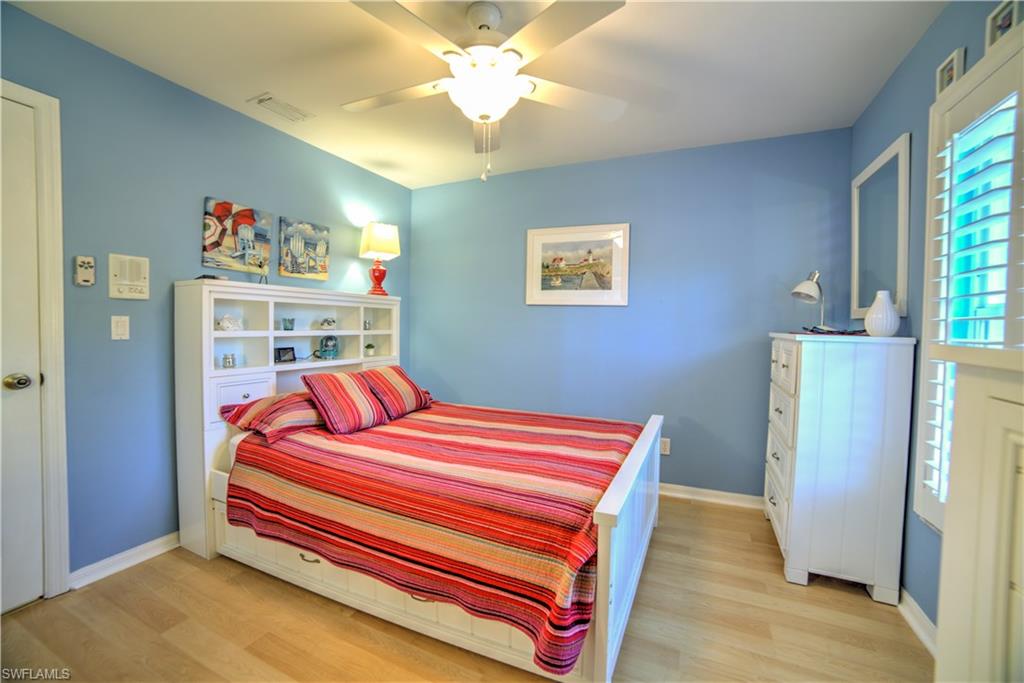 9143 Irving Road Fort Myers, FL 33967 - Photo 7 of 14 a bedroom with a bed and a chandelier