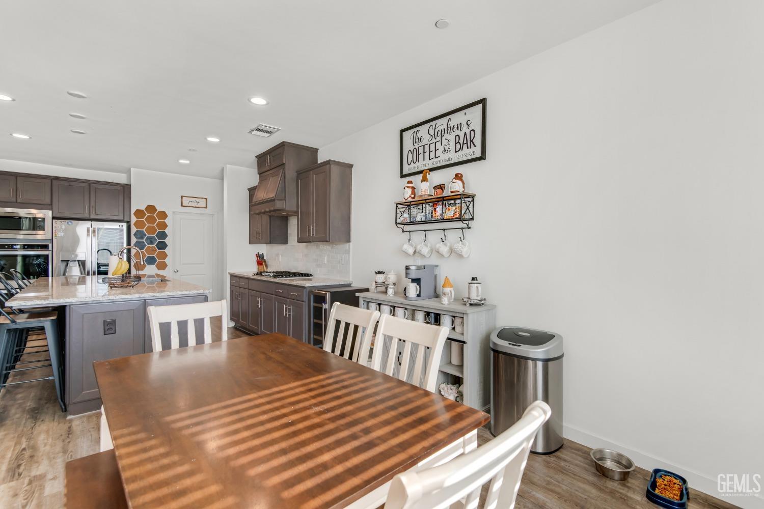Undisclosed Address Bakersfield, CA 93313 - Photo 12 of 45 a kitchen with a table chairs a stove a dining table and chairs