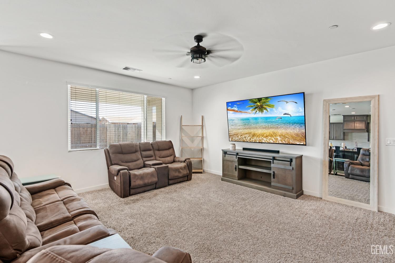 Undisclosed Address Bakersfield, CA 93313 - Photo 16 of 45 a living room with furniture and a flat screen tv