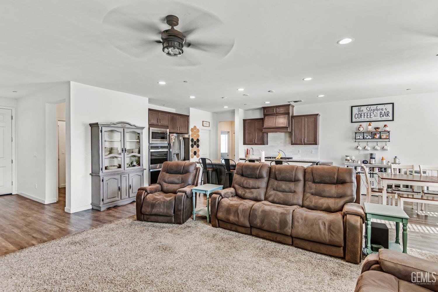 Undisclosed Address Bakersfield, CA 93313 - Photo 20 of 45 a living room with furniture a ceiling fan and a rug
