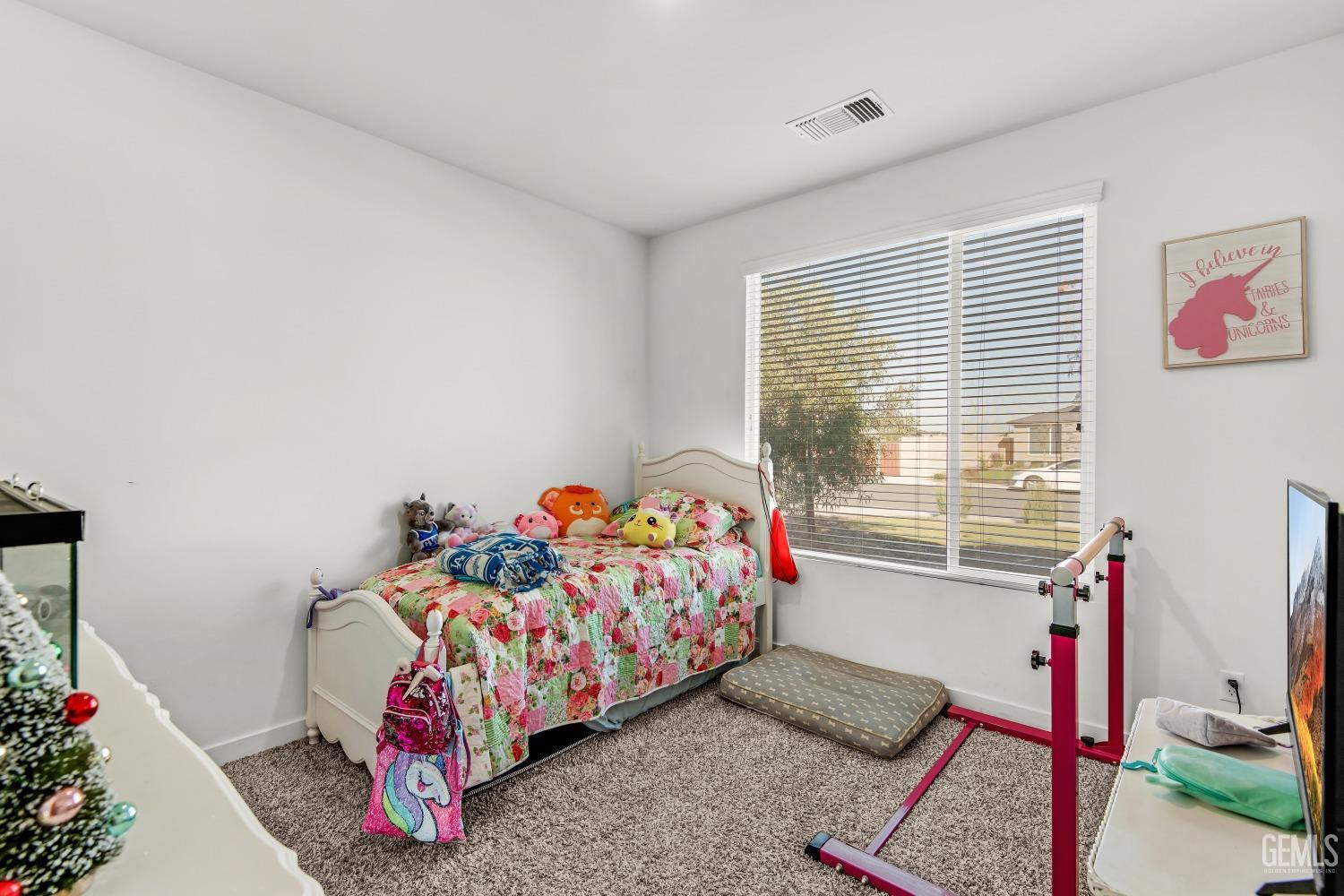 Undisclosed Address Bakersfield, CA 93313 - Photo 21 of 45 a bedroom with a bed and a window