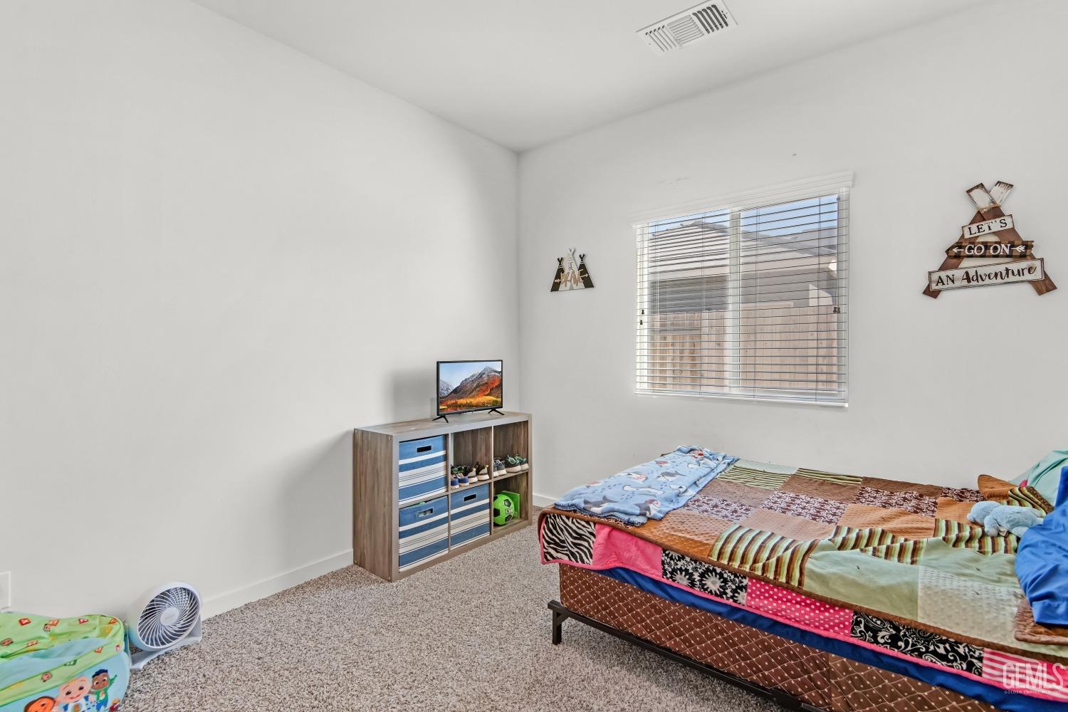 Undisclosed Address Bakersfield, CA 93313 - Photo 25 of 45 a bedroom with a bed and a window