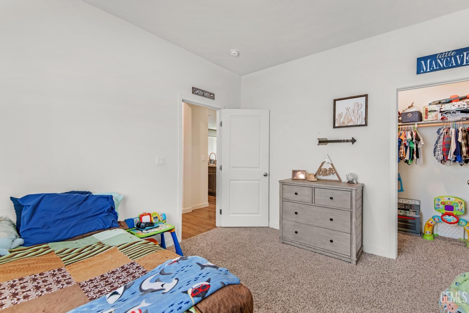 Undisclosed Address Bakersfield, CA 93313 - Photo 26 of 45 a bedroom with a bed and a dresser