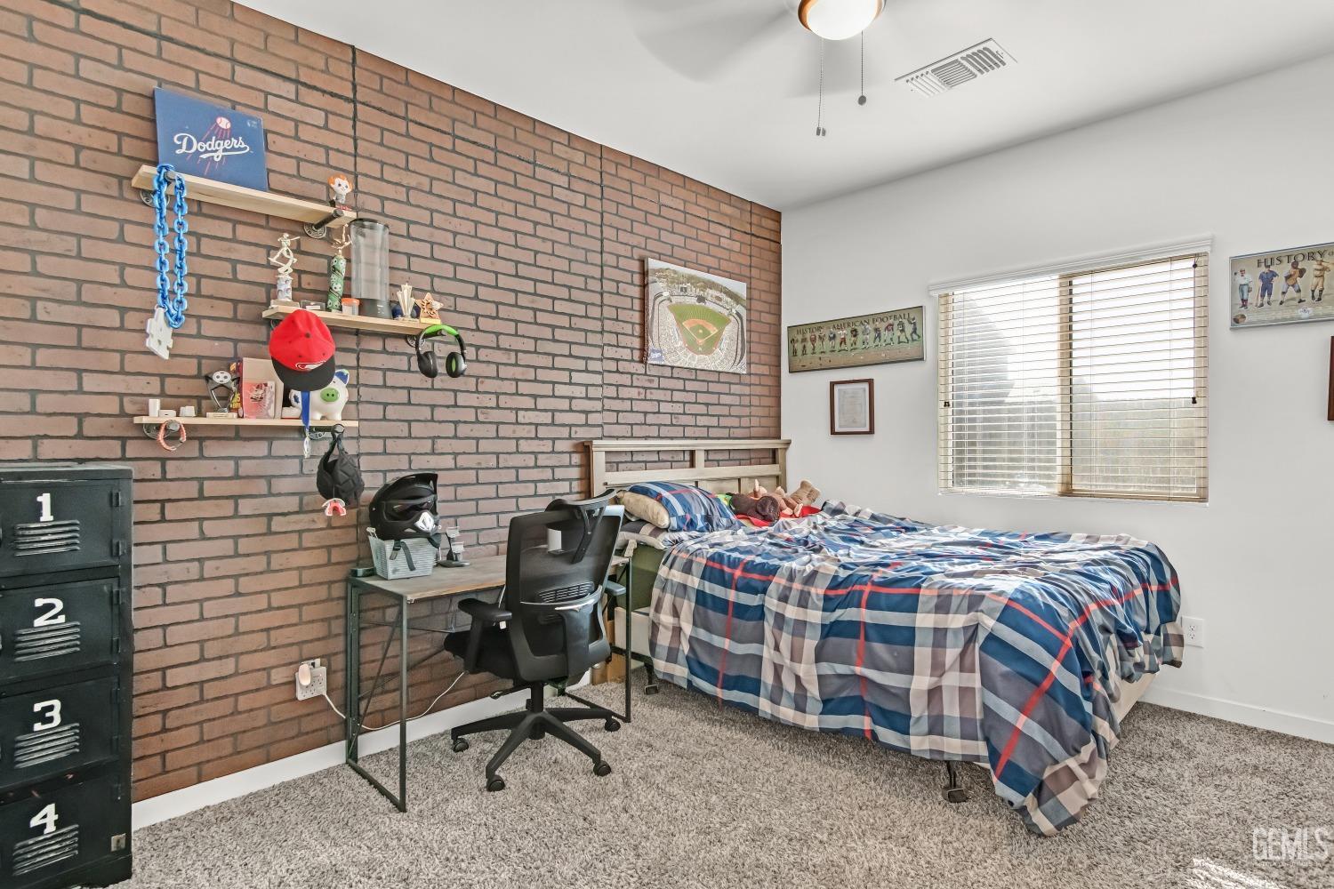 Undisclosed Address Bakersfield, CA 93313 - Photo 27 of 45 a bedroom that has a bed and a chair in it