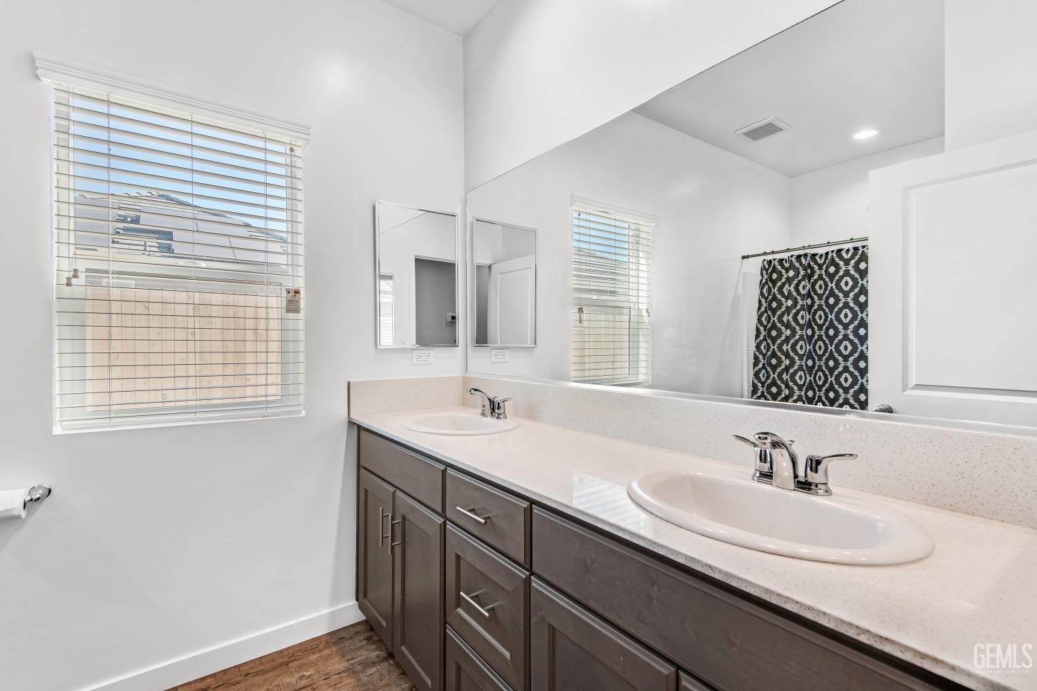 Undisclosed Address Bakersfield, CA 93313 - Photo 29 of 45 a bathroom with double sink and a mirror