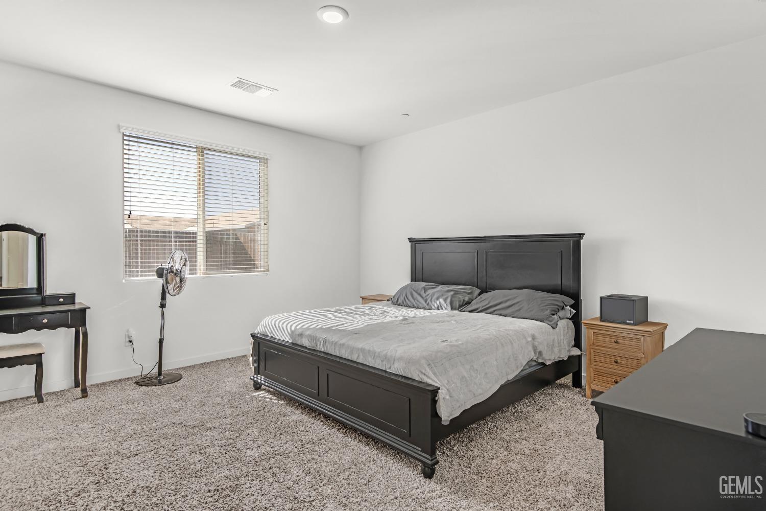 Undisclosed Address Bakersfield, CA 93313 - Photo 33 of 45 a bedroom with a bed and window