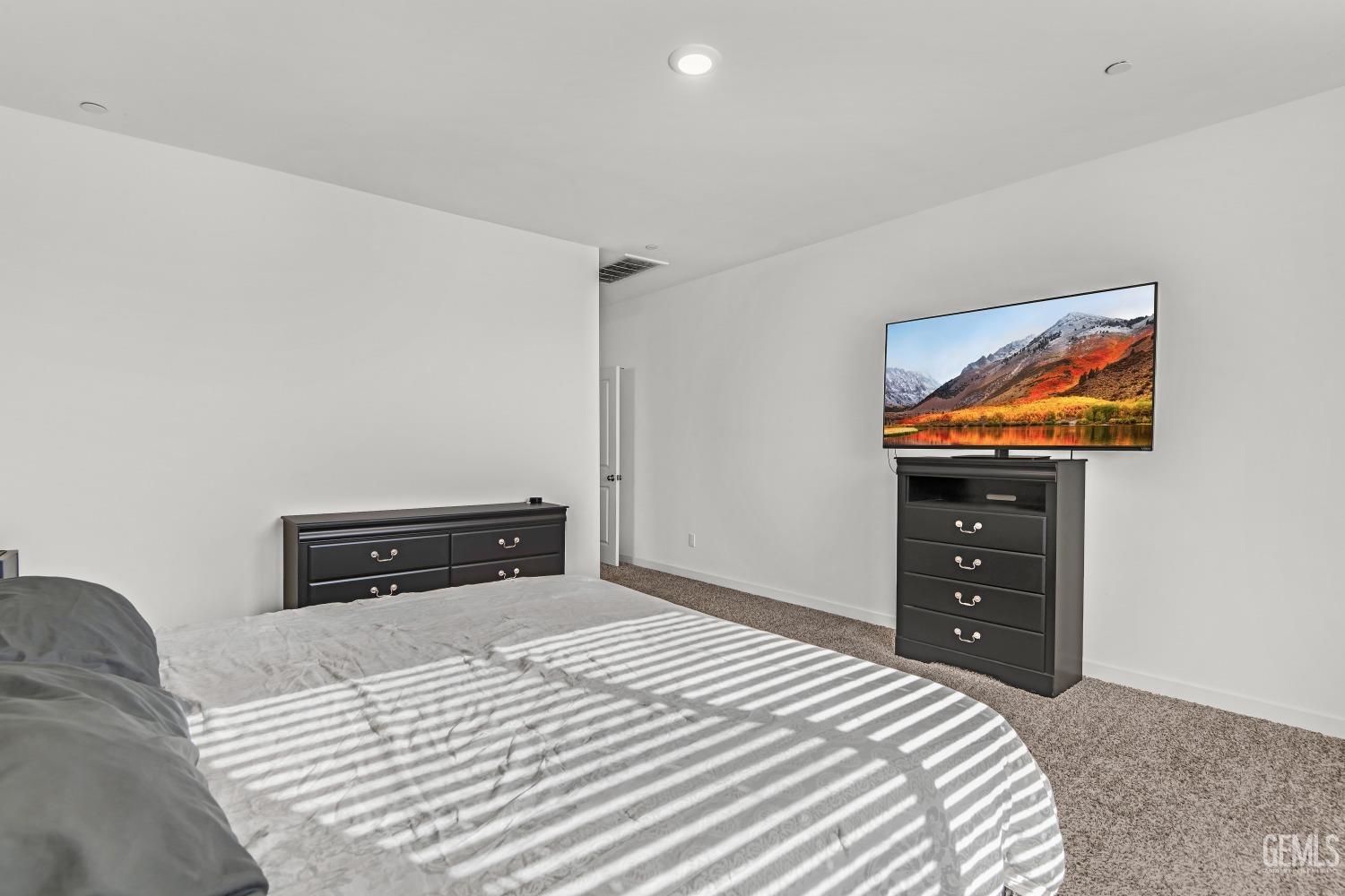 Undisclosed Address Bakersfield, CA 93313 - Photo 34 of 45 a bedroom with a bed and a window