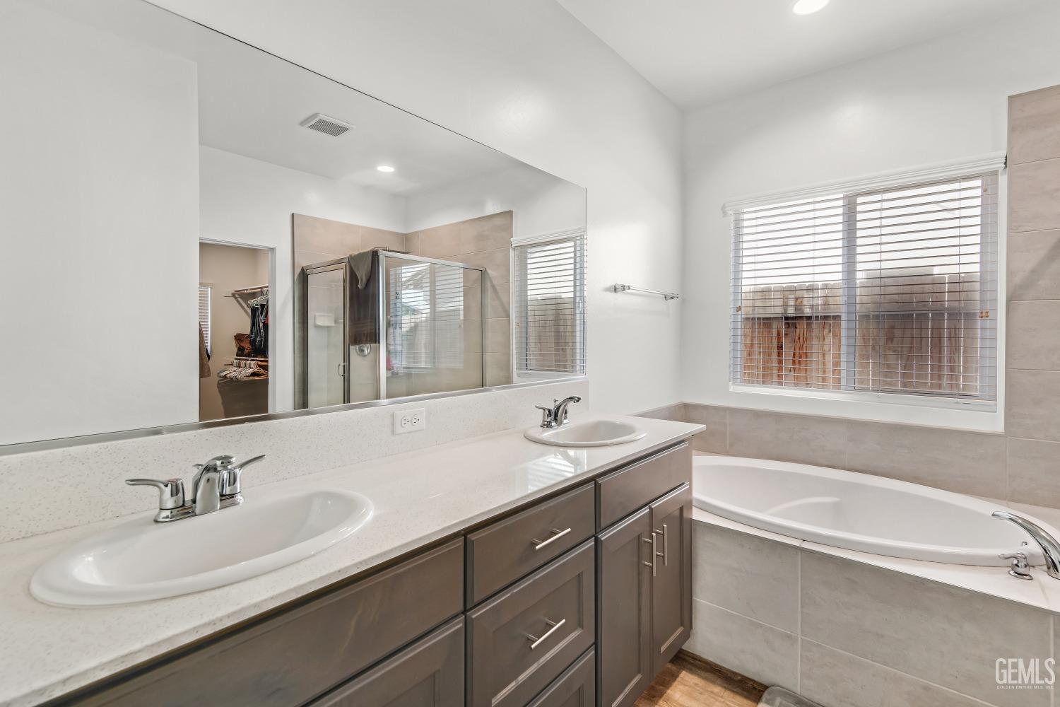 Undisclosed Address Bakersfield, CA 93313 - Photo 35 of 45 a bathroom with a sink double vanity granite tub shower and a mirror