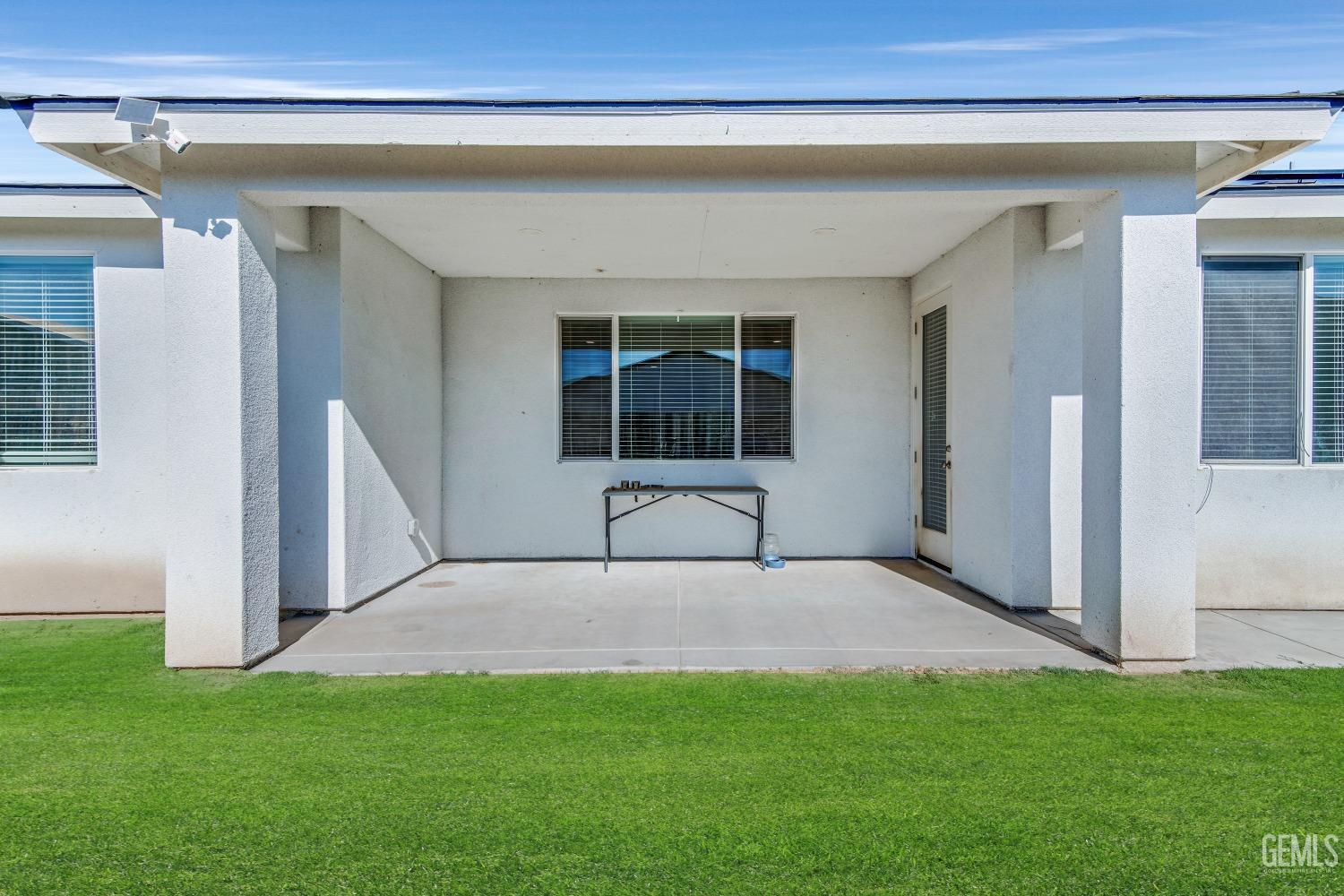 Undisclosed Address Bakersfield, CA 93313 - Photo 38 of 45 a view of a house with a porch and a yard