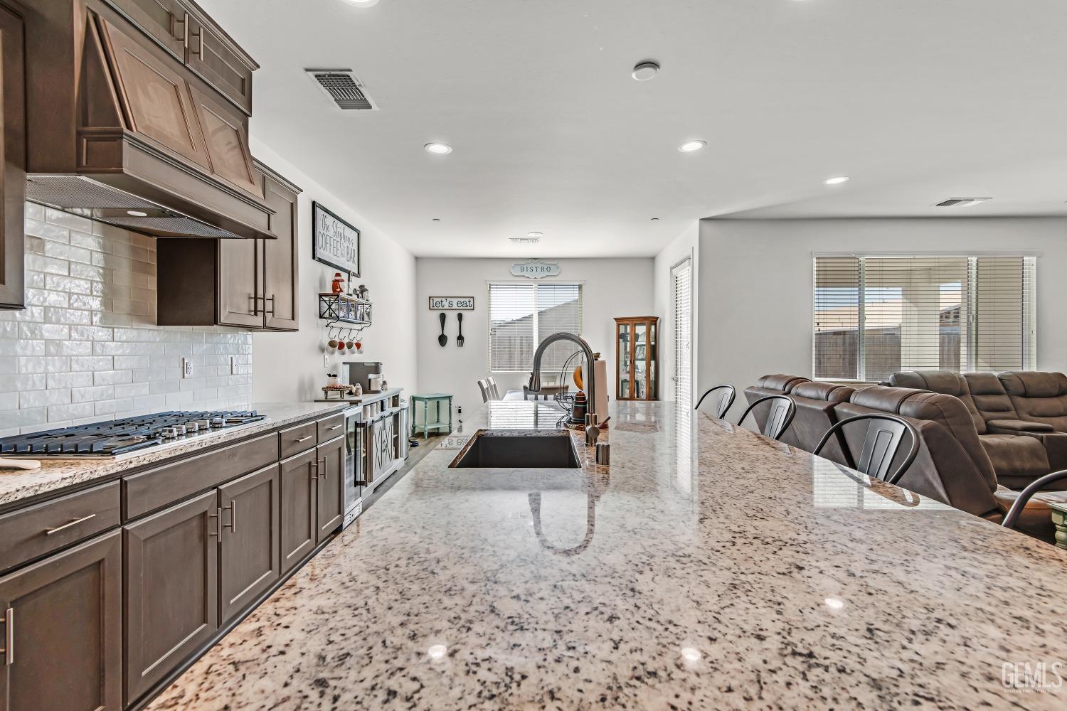 Undisclosed Address Bakersfield, CA 93313 - Photo 7 of 45 a view of a kitchen with sink a stove and furniture