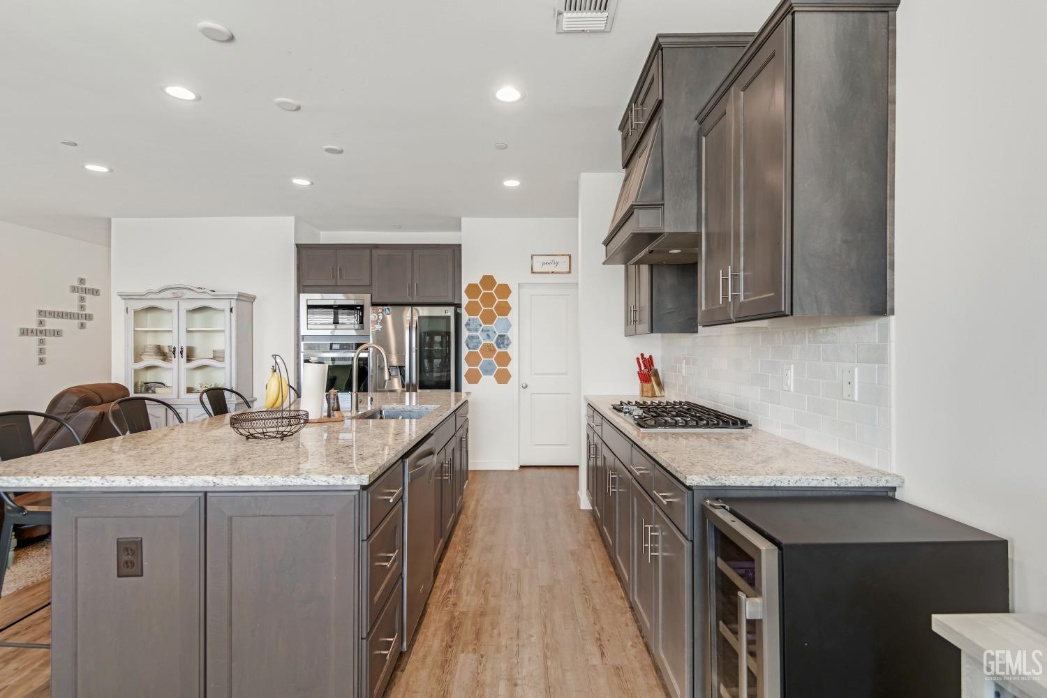 Undisclosed Address Bakersfield, CA 93313 - Photo 10 of 45 a kitchen with a sink stove and cabinets