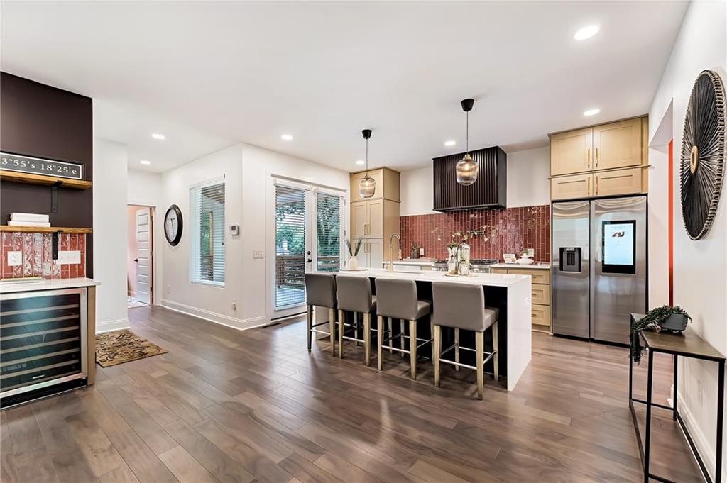 3087 Alston Drive Decatur, GA 30032 - Photo 1 of 1 a kitchen with stainless steel appliances granite countertop a refrigerator a stove top oven and a dining table with wooden floor
